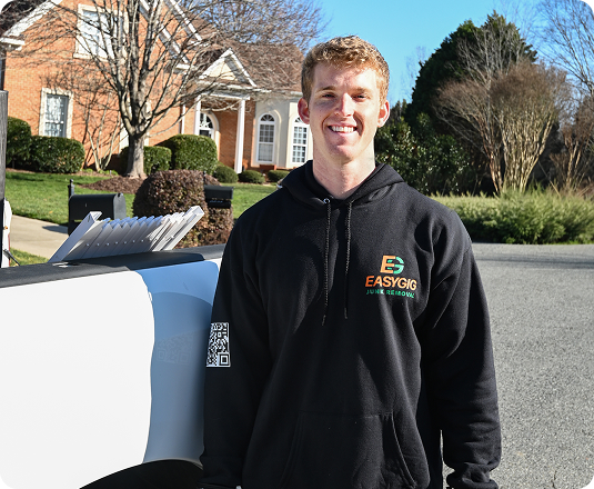 EasyGig Junk Removal's CEO, Brendan Little, standing next to a pickup truck full of junk removal in Waxhaw.