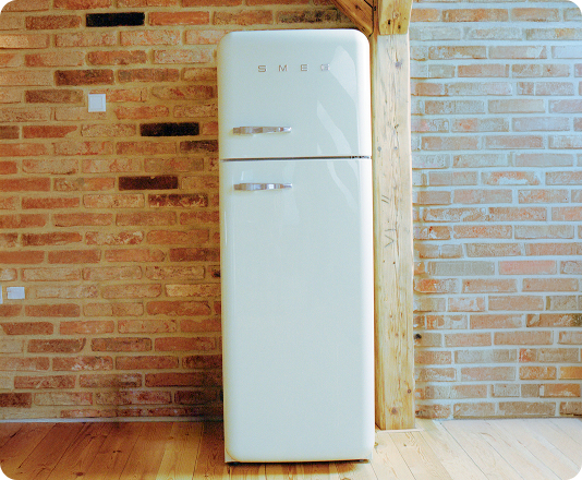 Old refrigerator waiting for junk removal pickup