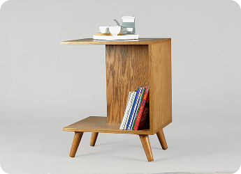 Side table filled with books and holding tea.