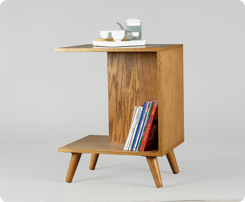 Side table filled with books and holding tea.