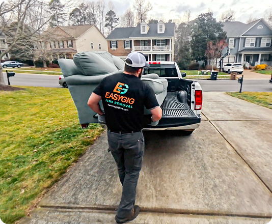 EasyGig hauler loading up a pickup truck with a couch donation for The Salvation Army