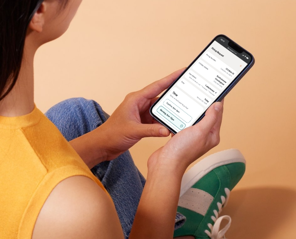 A woman using EasyGig's online booking process for same-day, fast, and simple junk removal.