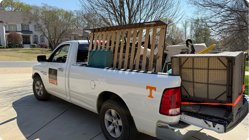 EasyGig junk removal pickup truck loaded with furniture and household items for curbside junk removal service in a residential neighborhood in Charlotte, NC