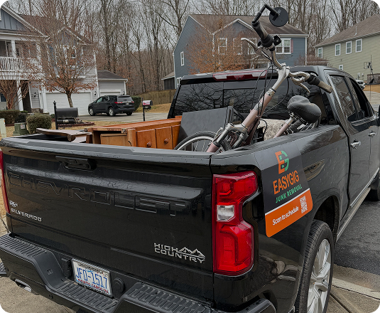 EasyGig junk removal truck with furniture and a bicycle loaded in pickup bed for residential junk removal service