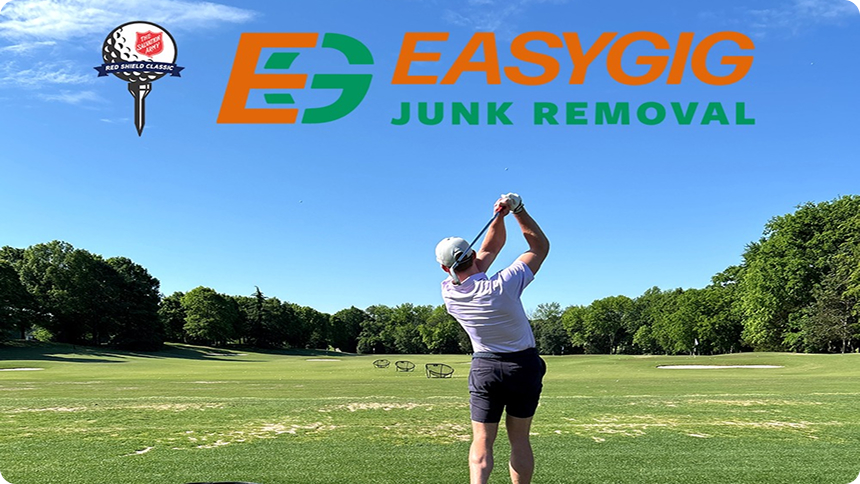 Golfer at driving range with EasyGig Junk Removal branding promoting Salvation Army donation pickup and Red Shield Classic in Charlotte