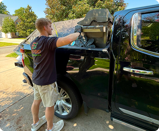 EasyGig Hauler loading up a pickup truck with mattresses and a grill.
