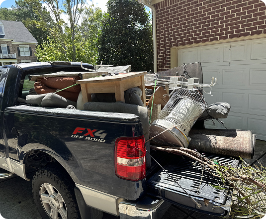 EasyGig pickup truck loaded with various unwanted household items ready to go to the dump