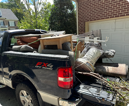 EasyGig hauler loading furniture into a pickup truckload for junk removal and donation pickup service