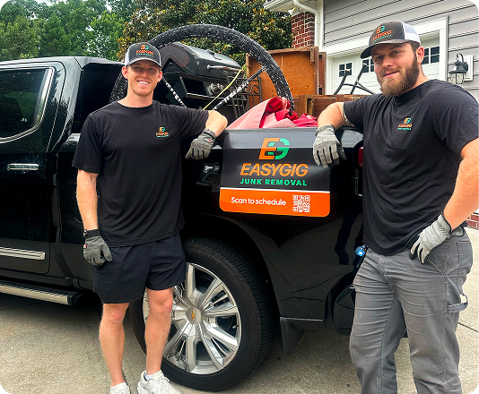 EasyGig junk removal haulers standing next to a loaded pickup truck.