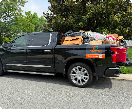 EasyGig Junk Removal pickup truck loaded with junk removal in a suburban neighborhood