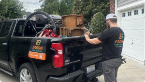 Hauler loading furniture into a pickup truck, showing what you need to start a junk hauling side hustle