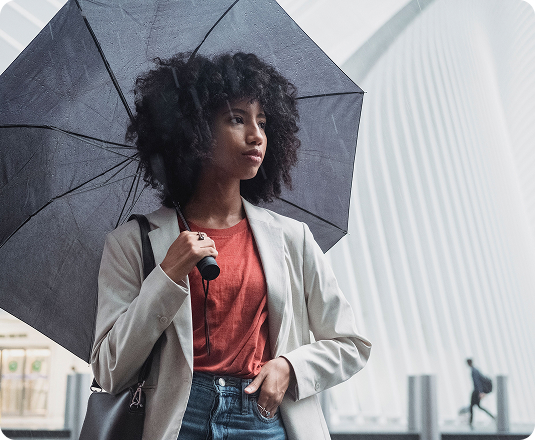 Woman holding an umbrella outdoors during a rainy day