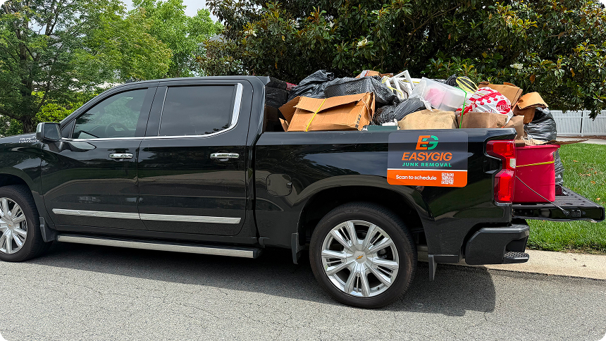 EasyGig Junk Removal pickup truck filled with household clutter in the truckbed