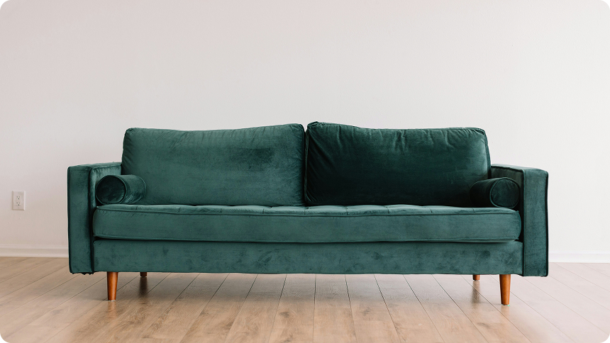 Teal couch in an empty room ready to be removed
