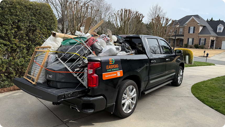 EasyGig Junk Removal pickup truck filled with general household junk.