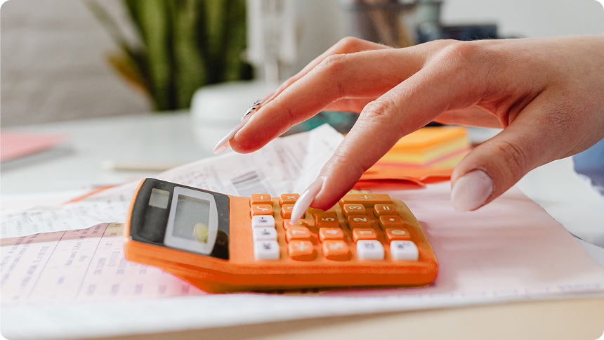 Person calculating junk removal prices on a calculator